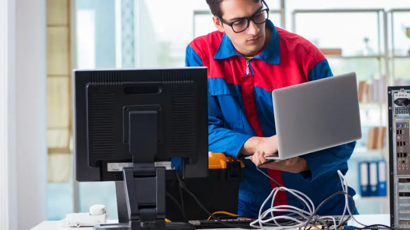 technician diagnosing computer hardware in workshop